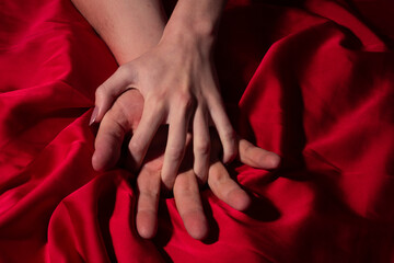 Couple sensual touch. Sex. Hands of lovers. Woman pulling sheets. Hands of love. Couple in love. Sensual hands concept. Tender couple in bed. Romance.