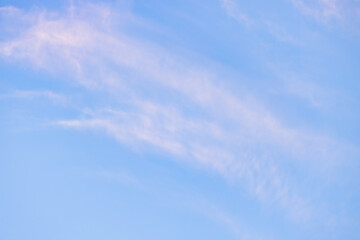 A beautiful sky tinted by the sun leaving vibrant shades of gold, pink, blue and multicolored. Clouds in the twilight evening and morning sky. Cloudy sky background in the evening, and during the day.