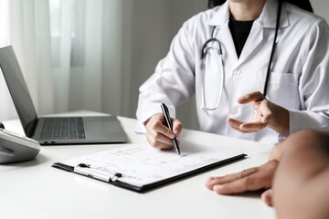 Female doctors who treat patients make an appointment to listen to the results after a physical examination and explain medical information and diagnose the disease. Medical concepts and good health
