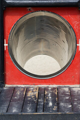 circular opening to metal slide at playground