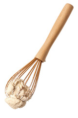 Baking whisk holding a clump of dough against a transparent background