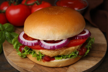 Delicious vegan burger with chickpea cutlet on wooden table, closeup