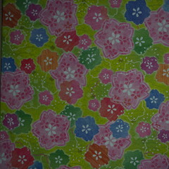 Traditional Japanese patterns with colorful floral theme and green background. 