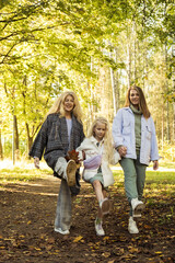 Fototapeta premium Lifestyle and people concept. Grandmother With Granddaughter And Mother In Autumn Park.