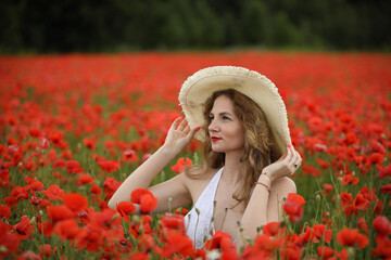 young woman in a field of poppies