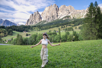 Woman enjoy view of Cortina D Ampezzo mountains landscape Dolomites, Italy.