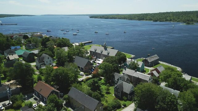 Aerial view of historic Shelburne harbour's Fishing Industry Tribute Memorial Park and Museums by The Sea, Nova Scotia, Canada.  MAX QUAL PRORES422HQ Transcode of 4K H.265 D-CINELIKE original capture.