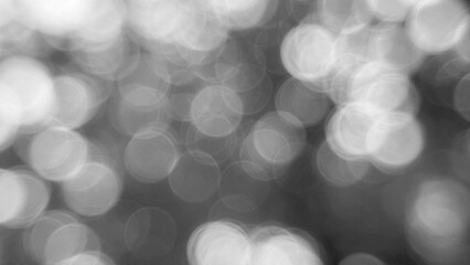 Abstract black and white background featuring a blurred pattern of circular shapes creating a soft and ethereal aesthetic.