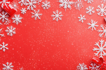 Festive red background with white snowflakes and decorative elements, creating cheerful winter atmosphere perfect for holiday celebrations