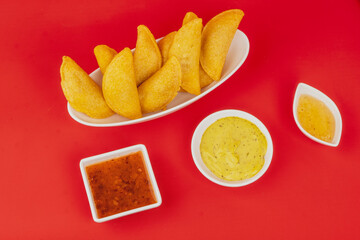 Colombian empanada with spicy sauce 