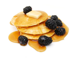 A stack of plain pancakes and syrup on a white background.