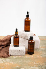 Amber Glass Bottles on Textured Stone Blocks with Minimalist Style
