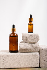 Amber Glass Dropper Bottles on Stone Pedestals with Fabric Decor