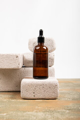 Amber Glass Dropper Bottles on Stone Pedestals with Fabric Decor