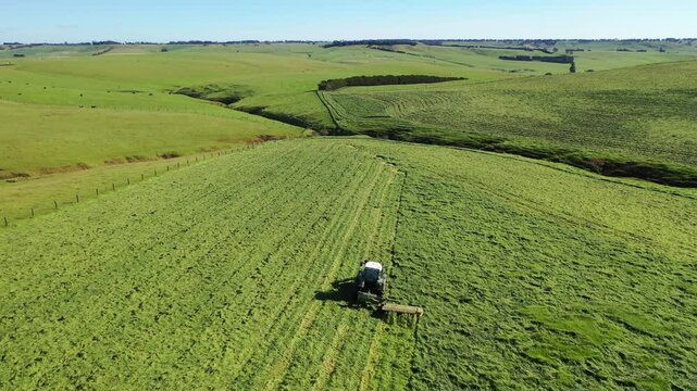 Making hay bales in a field In Australian. Baling silage rolls in a meadow 