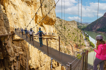 People crossing the suspension bridge of the Caminito del Rey