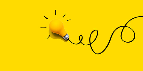 Brainstorming concept with a yellow light bulb - Flat lay