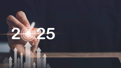 Target and goal of 2025 year business new year concept. Businessman touching future showing glowing...