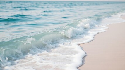 A serene soft blue ocean wave gently lapping against the shore of a tranquil beach on a warm summer day, shoreline, sunshine, gentle