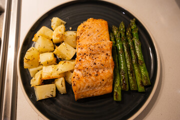 Roast potato, baked salmon, and grilled asparagus.