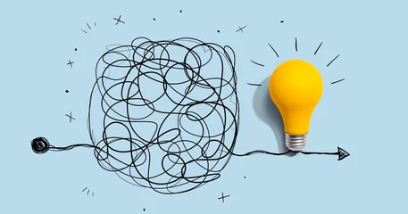 Clarifying complex ideas theme with light bulb - Flat lay © Tierney