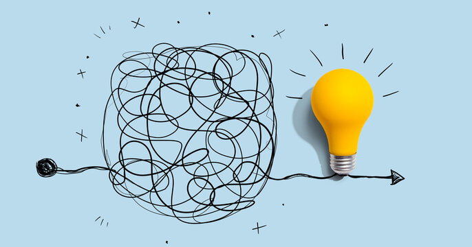 Clarifying complex ideas theme with light bulb - Flat lay