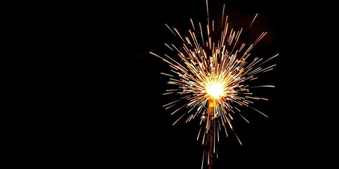 Fototapeta premium A burst of sparks erupts from the flames, creating a mesmerizing display against the dark backdrop, pyrotechnics, light