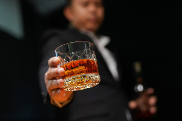 Closeup businessmen holding a glass of whiskey