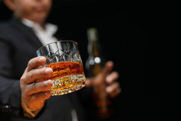 Closeup businessmen holding a glass of whiskey