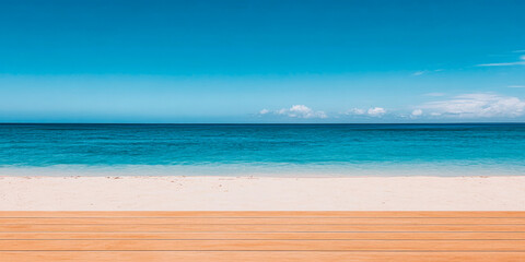 Fototapeta premium Serene sandy beach with crystal clear waters and wooden decking under a bright blue sky