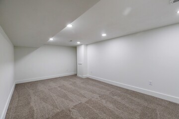 Interior view of a new, renovated empty room, with white walls, carpet flooring