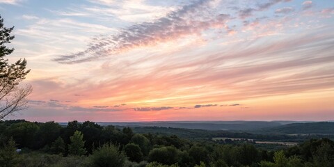 Obraz premium Watercolor brushstrokes create a soft, ombre-effect in the sky as the sun dips below the horizon, soft, background