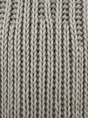 A close-up photo showcasing the intricate detail of a knitted fabric texture, textile