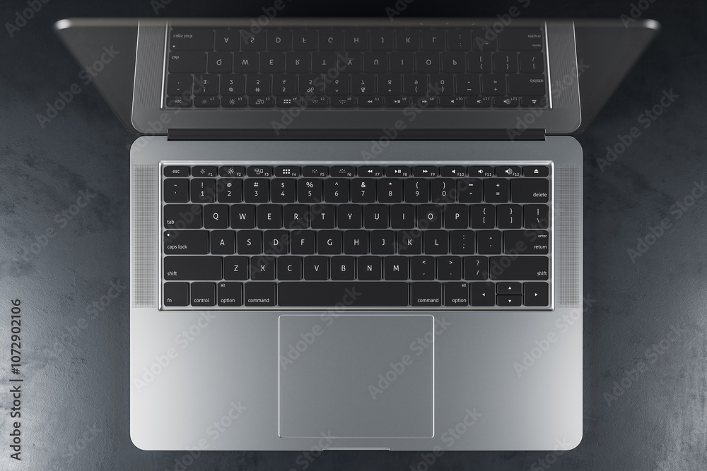 Poster Top view on modern laptop with black keyboard and reflection on screen on abstract dark concrete surface. 3D rendering
