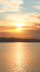 Sunset over the lake with mountains in the background, Indonesia.