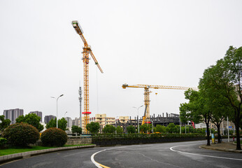 Construction cranes over high-rise residential apartments. Shanghai. China.