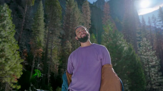 Portrait of African American young smiling hansom man, captured in Yosemite, showcasing the splendid beauty of nature, amidst stunning and picturesque landscapes