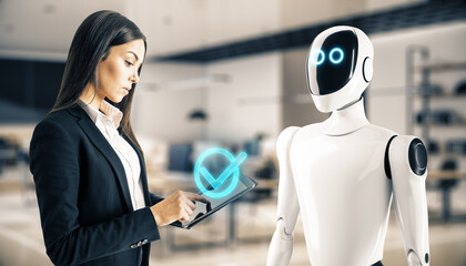 Businesswoman interacting with humanoid robot holding a tablet inside an office.
