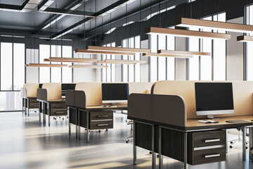Modern office workspace with computers, desks, and chairs in a bright interior with large windows and city view in the background. 3D Rendering
