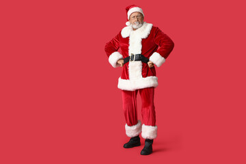 Suspicious Santa Claus in glasses on red background