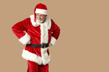 Santa Claus in glasses on brown background