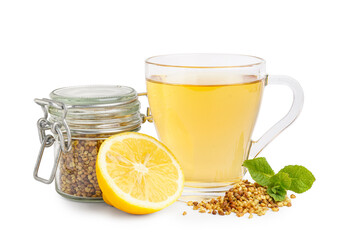 Glass cup of fresh buckwheat tea, mint and lemon on white background