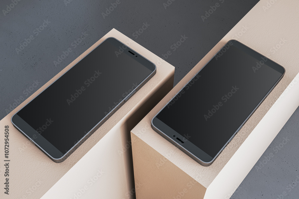 Poster two modern smartphones with blank screens on beige blocks, displayed against a smooth concrete backg