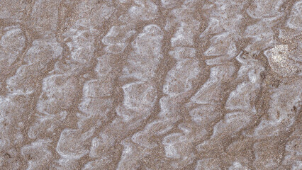 Abstract image of intricate patterns formed in the sand of a beach