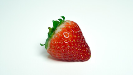 Close up of one strawberry isolated on white background