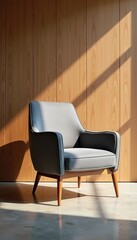 Obraz premium Modern gray armchair in a stylish setting, showcasing contemporary design and warm natural light, perfect for home decor, interior design projects, or furniture advertising.