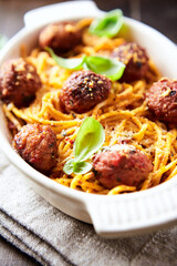 Spaghetti Pasta with Meatballs and fresh Basil o bright background. Close up.