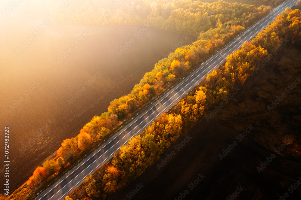 Aufkleber panoramic view from above of the freeway passing through agricultural fields in the morning light.