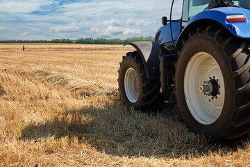 A large tractor  standing in a field. Start tillage after harvest. Preparation for work of agricultural equipment. © SKfoto