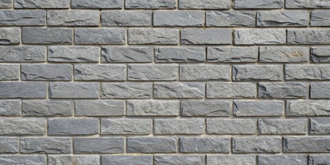 A seamless pattern of gray stone bricks with irregular texture and subtle variations in color